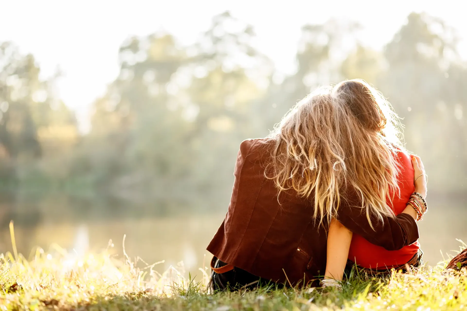two woman friends on grass