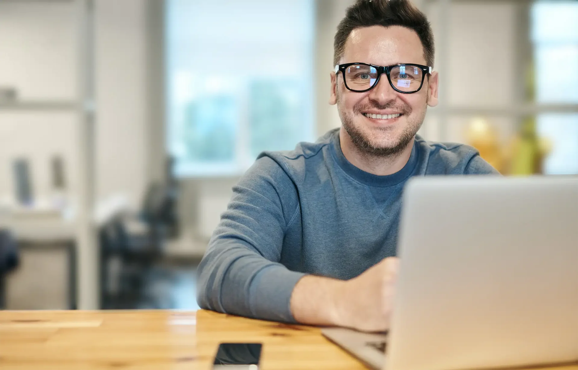 man at table with laptop