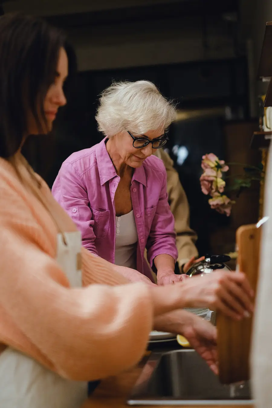 woman cleaning together in kitchen