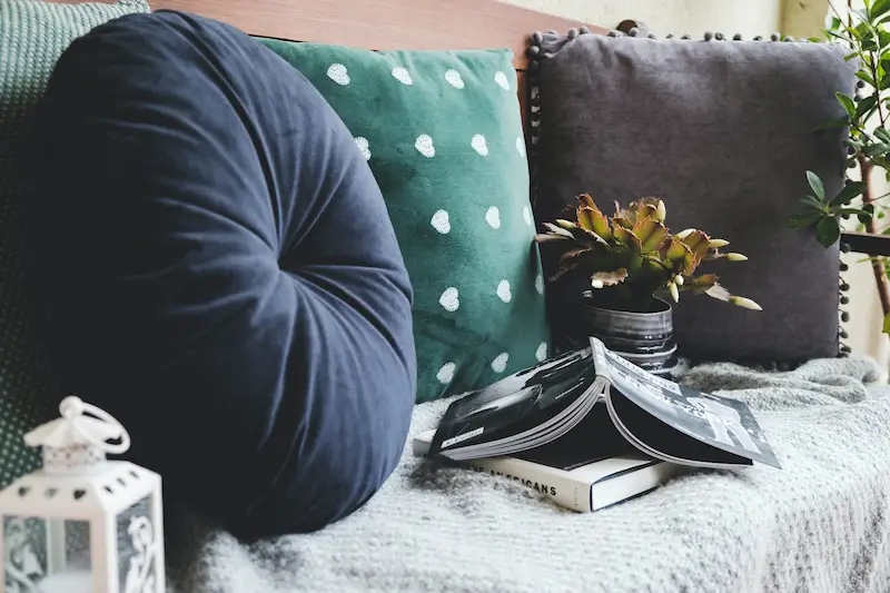 couch with throw pillows and books in a home